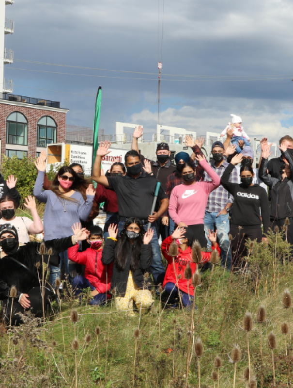 Image of ReForest London staff and Harvey's staff in a group photo together at a planting event.