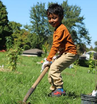 Boy planting at Arthur Ford Park